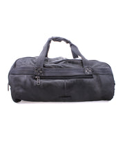 A black leather duffel bag with durable canvas straps, handles, and a front zippered pocket called the Ruslan by Bed Stu.