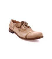 A light brown suede lace-up dress shoe with a rounded toe and dark brown sole viewed from the side, featuring a high-quality suede upper, the Sandstorm by Bed Stu.