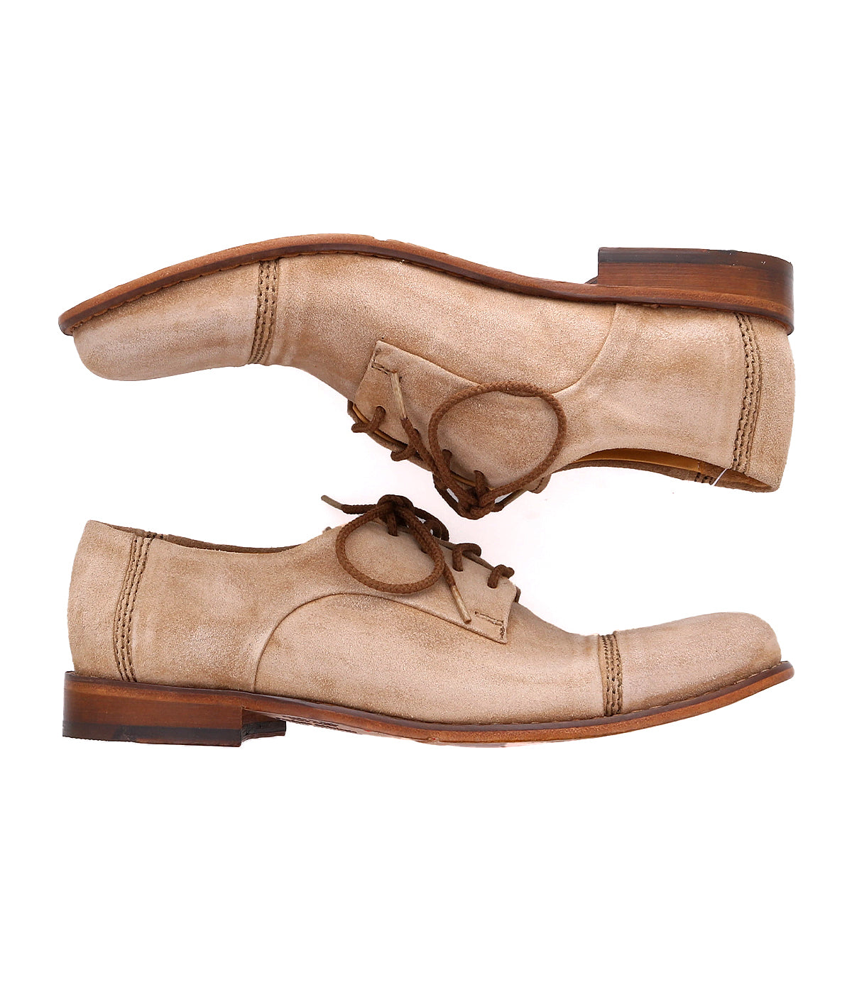 Pair of beige lace-up handmade Sandstorm derby shoes by Bed Stu with brown soles, featuring a suede upper, placed side by side facing opposite directions on a white background.