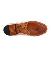 The sole of a brown leather Sandstorm with visible text reads "Made in Italy," "Prototipo fabbricato in Italia," and "43." This exquisite Bed Stu footwear features a suede upper and is crafted from vegetable-tanned leather, representing the finest craftsmanship.