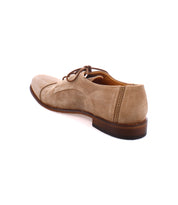 A beige suede Oxford shoe with brown laces and a dark brown sole, featuring a beautifully crafted suede upper, viewed from the back and slightly to the side. Product Name: Sandstorm Brand Name: Bed Stu

Replaced Sentence:
The Bed Stu Sandstorm is a beige suede Oxford shoe with brown laces and a dark brown sole, featuring a beautifully crafted suede upper, viewed from the back and slightly to the side.