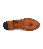 Bottom view of a brown handcrafted leather boot with visible stitching around the sole, the heel is black, and text printed on the sole reads "Made in Italy" along with other information. The size is marked as 43. This is the Scoot by Bed Stu.