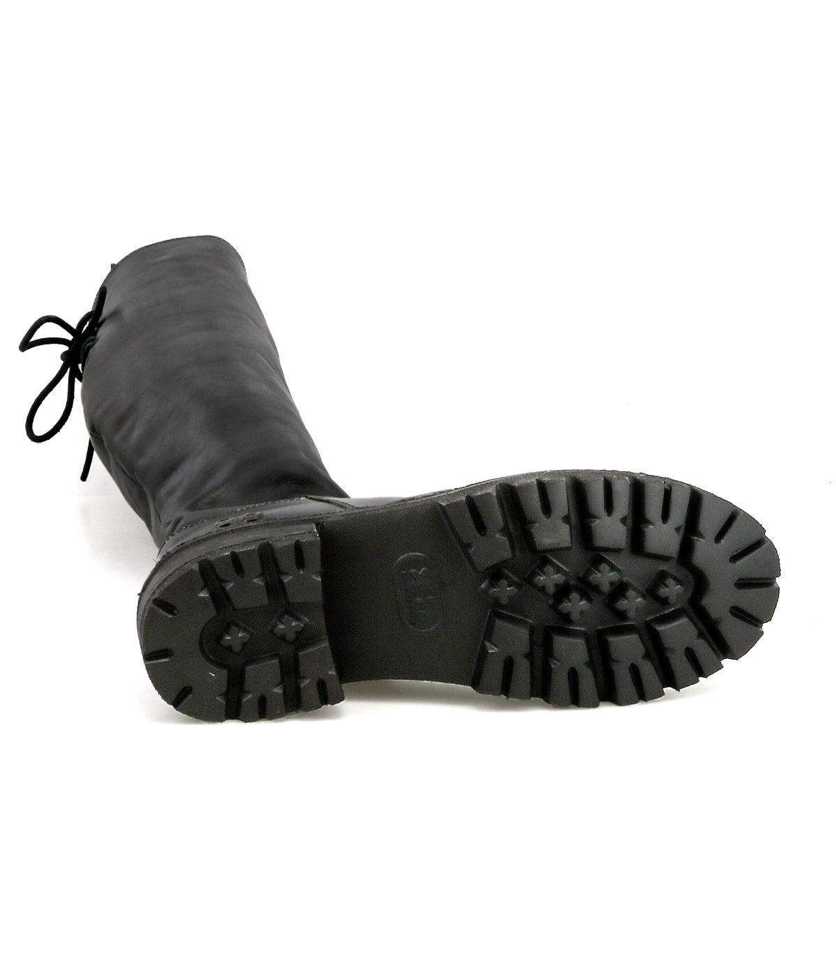 The Bed Stu Scope is a tall black women’s leather boot, shown lying on its side to highlight the boot’s rugged tread pattern.