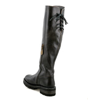 The Bed Stu Scope is a black, knee-high women’s boot with a side zipper and lace-up back, crafted from vegetable-tanned leather. Shown from the rear on a white background.