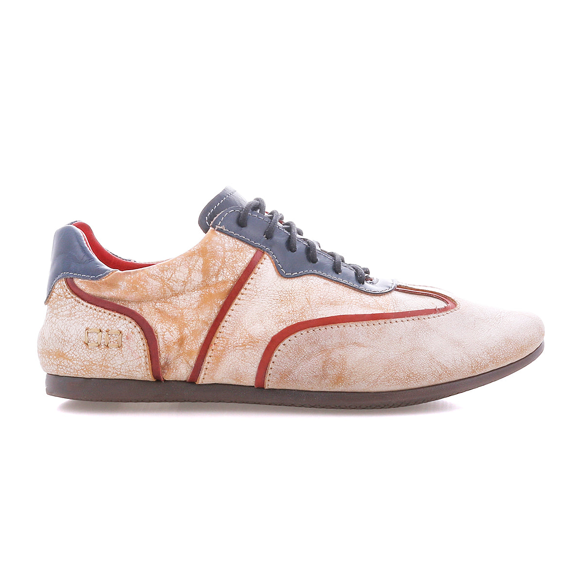 The Bed Stu Scurry II is a beige and orange casual sneaker with a low-profile silhouette, gray laces and sole, red trim, and textured side pattern.