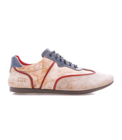 The Bed Stu Scurry II is a beige and orange casual sneaker with a low-profile silhouette, gray laces and sole, red trim, and textured side pattern.
