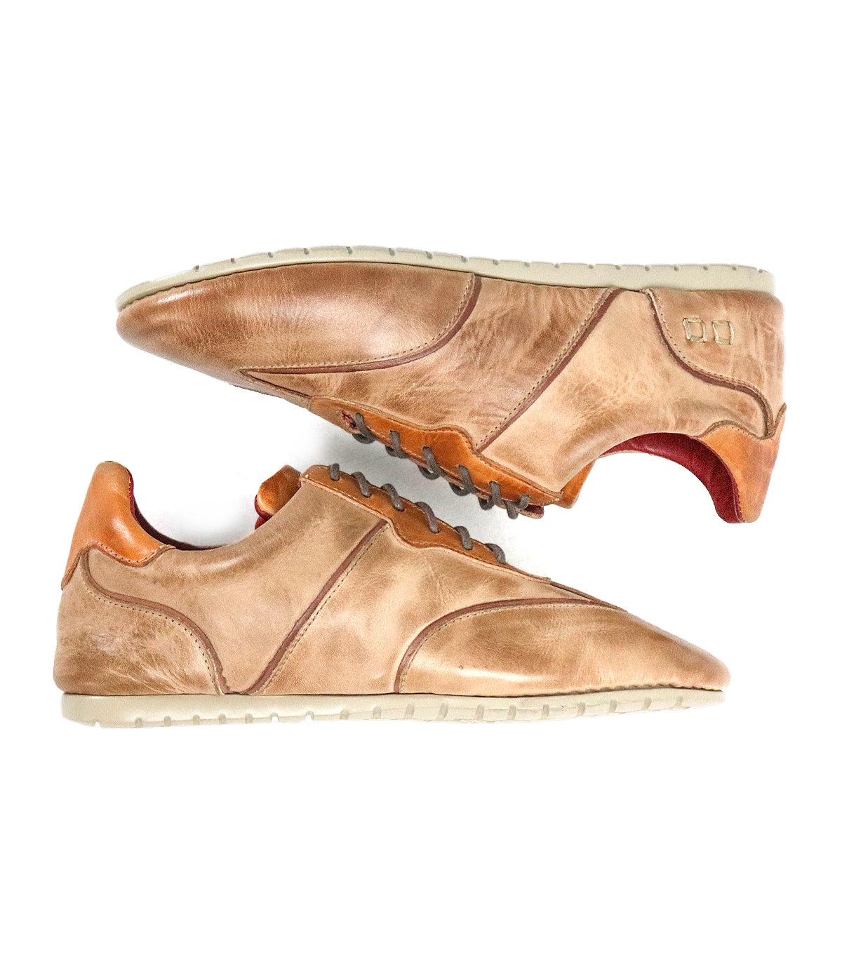 A pair of Bed Stu Scurry women's sneakers in brown sustainable vegetable-tanned leather with tan soles and orange accents, shown side by side on a white background.