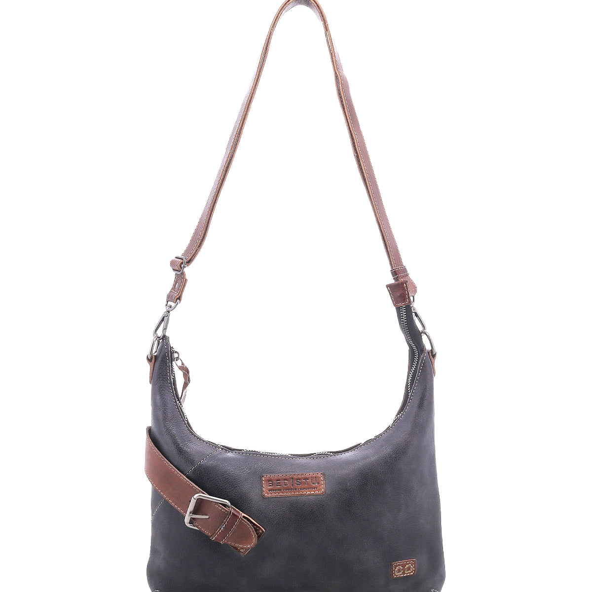 The Bed Stu Seemly is a black leather shoulder bag with a brown adjustable strap, zipper closure, front logo patches, and a subtle buckle—ideal for compact bag lovers and effortless everyday style.