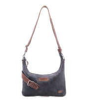 The Bed Stu Seemly is a black leather shoulder bag with a brown adjustable strap, zipper closure, front logo patches, and a subtle buckle—ideal for compact bag lovers and effortless everyday style.