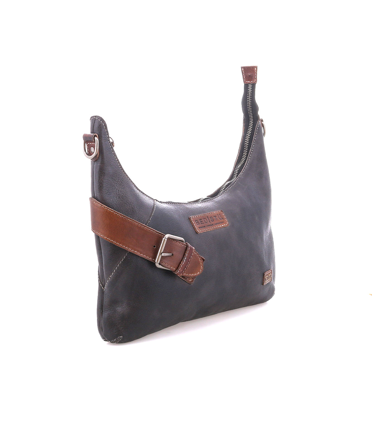 The Bed Stu Seemly is a black leather shoulder bag with a brown strap, buckle accents, zippered top, and patch label—ideal as a compact, everyday accessory.