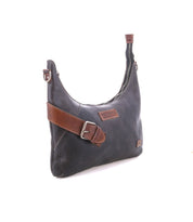The Bed Stu Seemly is a black leather shoulder bag with a brown strap, buckle accents, zippered top, and patch label—ideal as a compact, everyday accessory.