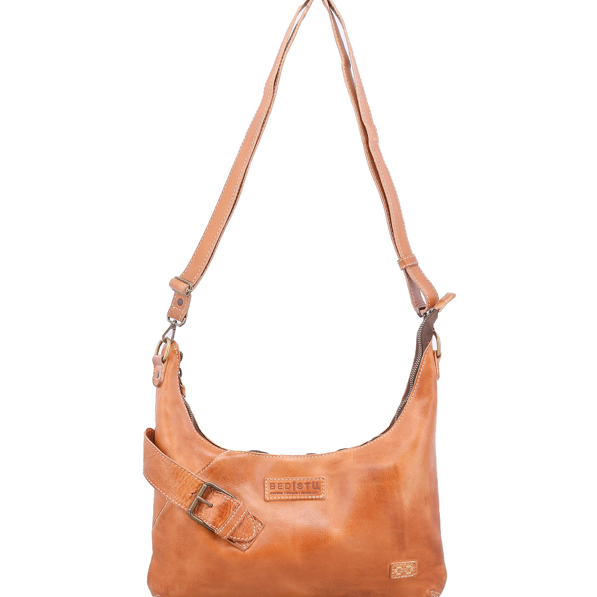The Bed Stu Seemly is a compact tan leather shoulder bag featuring an adjustable strap, decorative buckle, and a front logo patch—ideal for everyday style.