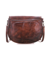 The Bed Stu Sequoia EM is a brown vegetable-tanned leather crossbody saddle bag with embossed flap detailing, a front flap closure, and an adjustable strap, shown against a white background.