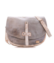 The Sequoia messenger bag by Bed|Stü is crafted from vegetable-tanned, weathered gray leather and features a long adjustable crossbody strap and a front buckle detail, shown against a white background.