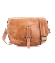 The Bed Stu Sequoia is a brown vegetable-tanned leather crossbody bag featuring a front flap, buckle strap closure, and an adjustable strap for comfortable carrying.