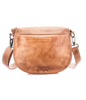 The Sequoia by Bed Stu is a light brown crossbody bag made from vegetable-tanned leather, featuring a curved flap, adjustable strap, and visible stitching.