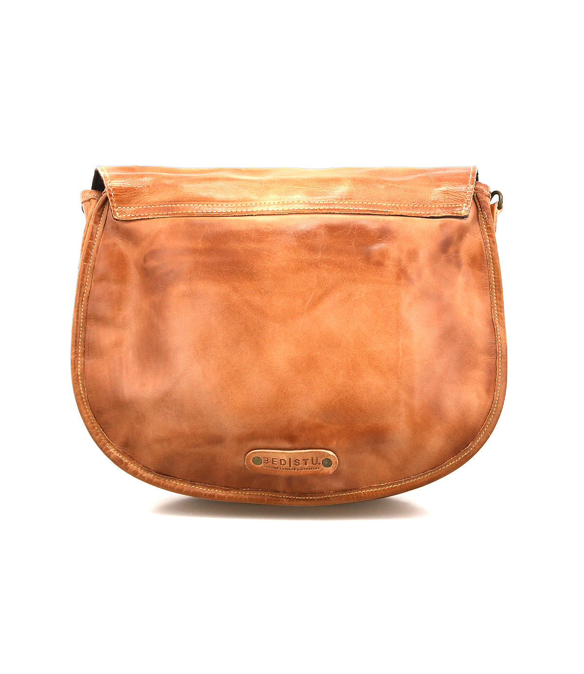 The Sequoia crossbody bag by Bed Stu is made from vegetable-tanned leather in tan, with a flap closure, adjustable strap, and a small metal logo plate on the front.