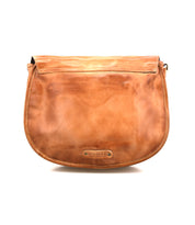 The Sequoia crossbody bag by Bed Stu is made from vegetable-tanned leather in tan, with a flap closure, adjustable strap, and a small metal logo plate on the front.