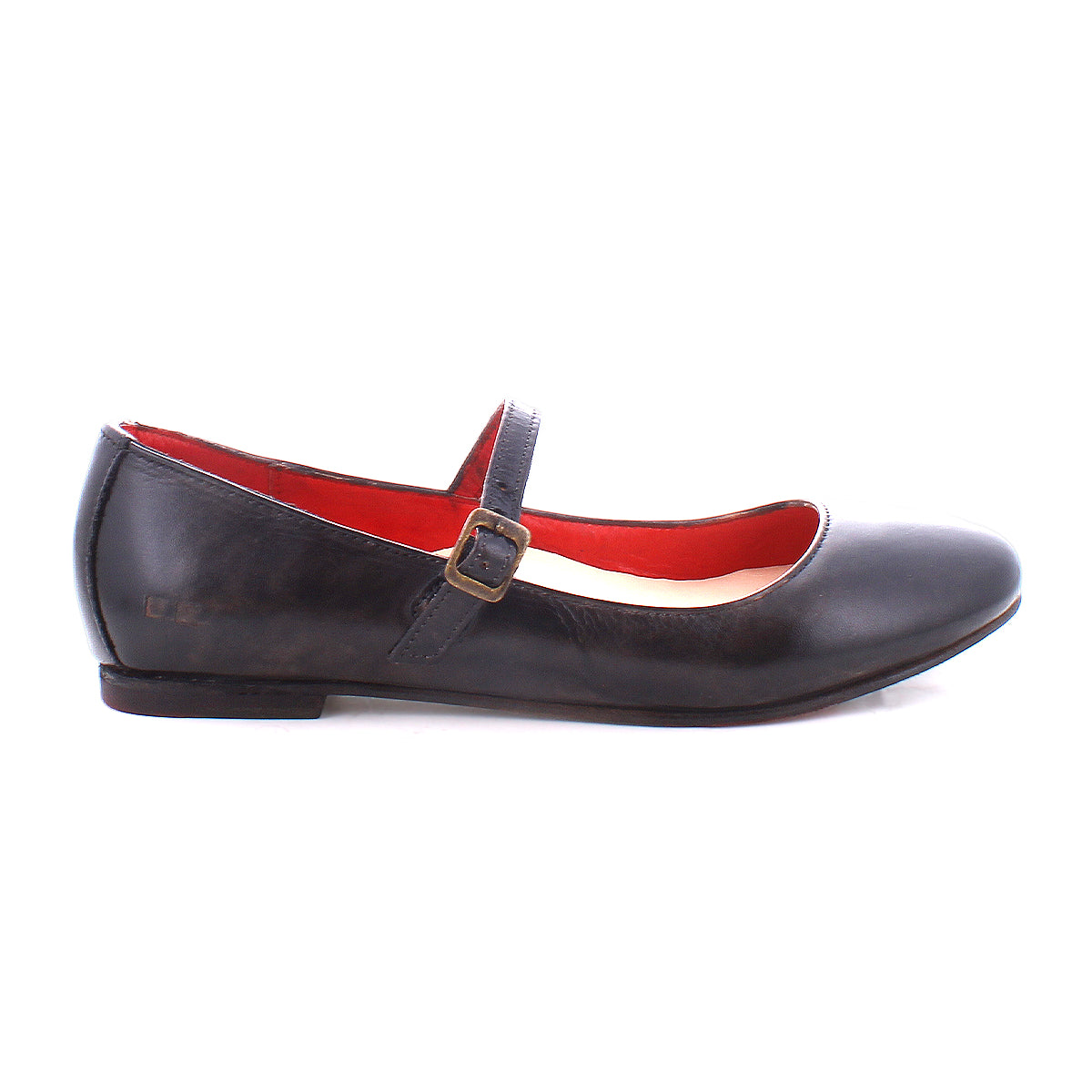 The Shuffle III by Bed Stu is a black leather Mary Jane ballet flat with an adjustable strap and buckle on the side. The interior lining is red, embracing the ballerinacore trend perfectly.