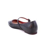 A black leather Shuffle III ballet flat by Bed Stu with an adjustable strap across the instep, viewed from the back.
