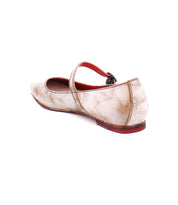 A worn beige Shuffle III by Bed Stu with an adjustable strap and visible scuff marks, viewed from the back side.