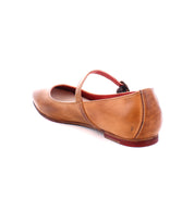 A single tan leather Mary Jane Shuffle III shoe by Bed Stu with an adjustable strap across the top, viewed from the rear side against a white background, showcases a refined elegance reminiscent of the ballerinacore trend.