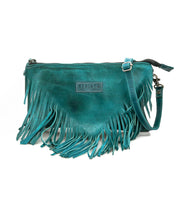 The Bed Stu Silverrock is a teal leather crossbody clutch with fringe detailing, zipper closure, adjustable strap, and a front brand label.