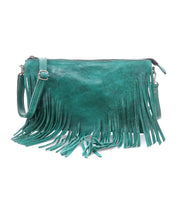 The Bed Stu Silverrock is a teal leather small crossbody bag with a long strap and chic fringe detailing along the bottom and sides.