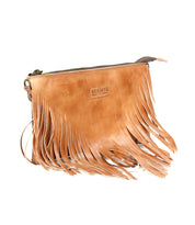 The Bed Stu Silverrock is a tan leather crossbody clutch with the brand logo, long fringe on the front, and a top zipper closure.