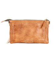 A rectangular tan leather crossbody clutch called Silverrock by Bed Stu, featuring a zipper closure and a small "BED|STU" logo tag on the front.