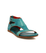 The Bed Stu Soto is a teal leather sandal with an open toe, ankle-high design, and side cutouts, featuring a cushioned footbed for all-day comfort. Displayed on a white background.