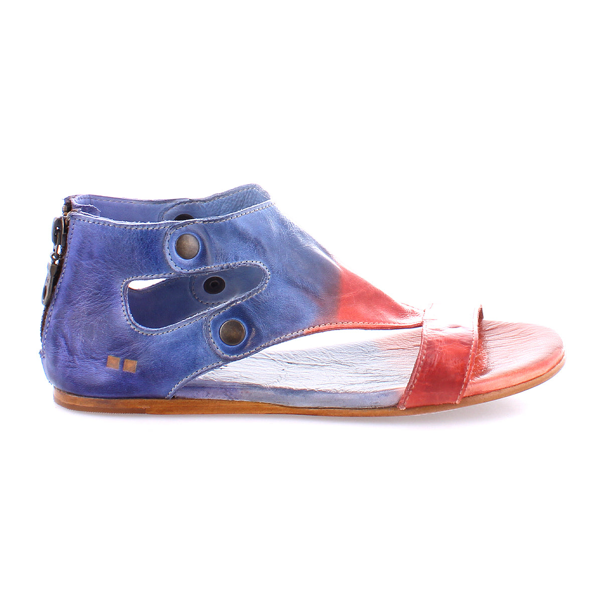 A single, colorful Soto shoe with an asymmetrical cutout design, featuring blue and red panels, a pointed toe, and a zipper on the side by Bed Stu.