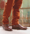 A person wearing a pair of Bed Stu Spiker shoes with exceptional traction.