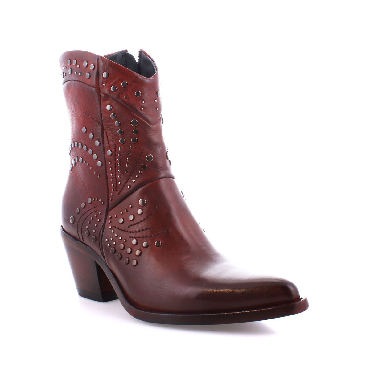 Introducing the Sposa by Bed Stu: an ankle bootie crafted from brown vegetable-tanned leather, adorned with decorative stitching and metal studs. It also features a block heel and a convenient side zipper.