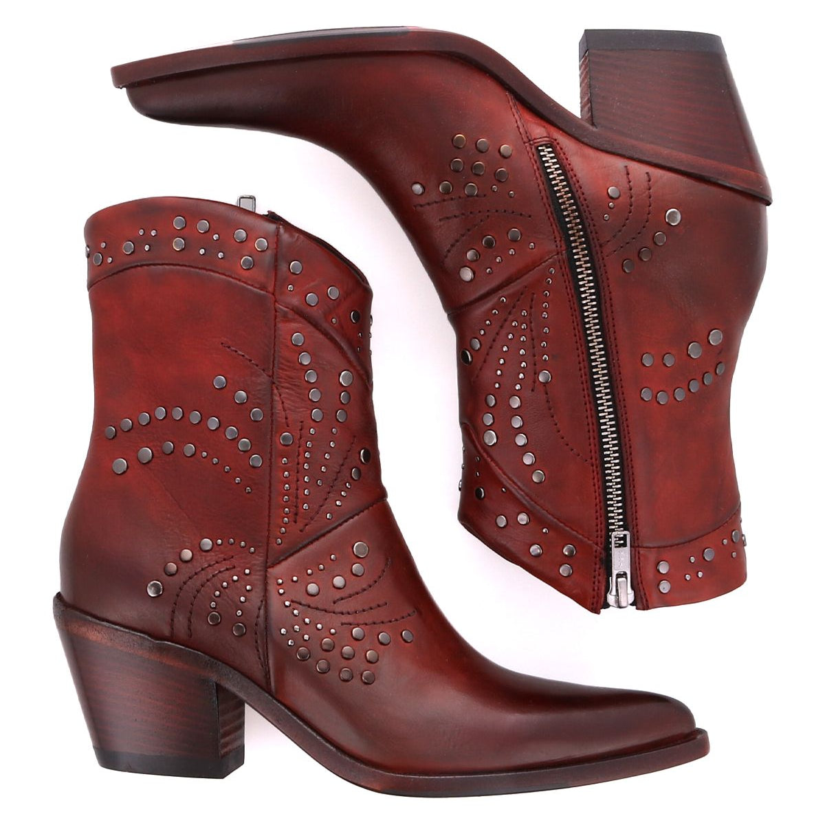 Introducing the Sposa by Bed Stu: a pair of brown leather booties adorned with decorative stitching and metal studs. One bootie is showcased standing upright, while the other lies on its side, highlighting the zipper and heel crafted from premium vegetable-tanned leather.