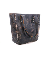 The Bed Stu Stevie is a vintage-inspired distressed brown leather tote with double handles and visible side stitching, perfect for daily use. Shown here against a white background.