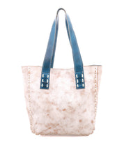 The Stevie by Bed Stu is a beige leather tote bag with a marbled texture, blue leather handles, and stitched edge detailing—an ideal choice for everyday carry.