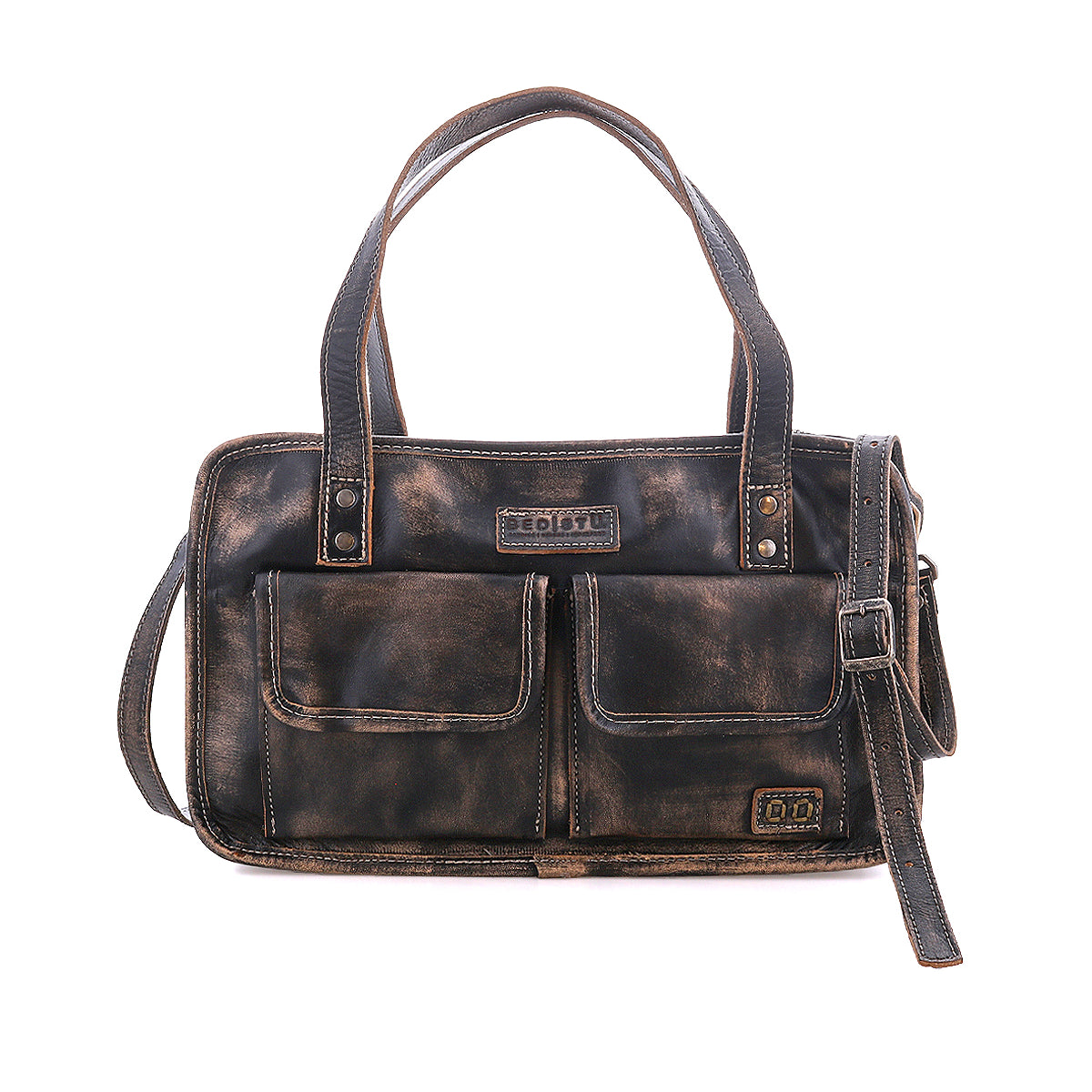 The Bed|Stü Stuffy is a brown leather handbag featuring a spacious interior, two front flap pockets, dual handles, and an adjustable shoulder strap, shown against a white background.