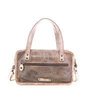 The Bed|Stü Stuffy is a rectangular brown leather handbag with a structured silhouette, double handles, a front zip pocket, and a detachable shoulder strap. It features a spacious interior and is displayed against a white background.