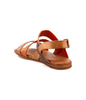The Bed Stu Superb, a brown leather sandal with multiple straps and an adjustable ankle strap, is shown from a rear side angle on a white background.