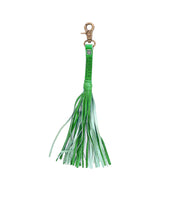 The Tassel Clip by Bed Stu is a green keychain made from premium leather, featuring a metal clip on top and fringed strands hanging down.