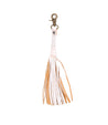 A white leather Tassel Clip keychain with tan tassels, perfect for adding a touch of personal expression to your accessories.