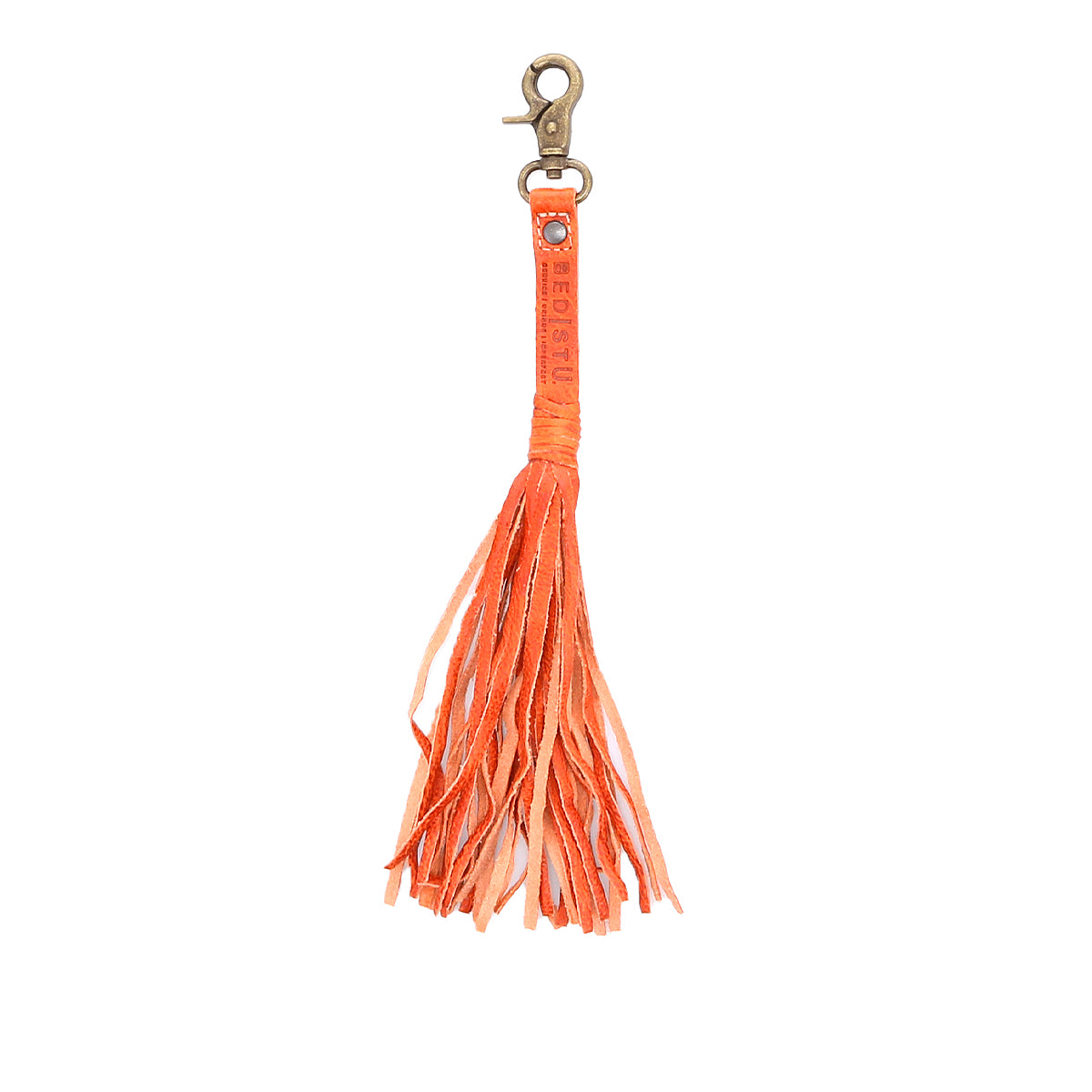A vibrant orange Bed Stu tassel clip for personal expression on a clean white background.