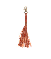 The Tassel Clip by Bed Stu is a premium leather keychain in orange with a bronze lobster clasp, adding a touch of personal expression.