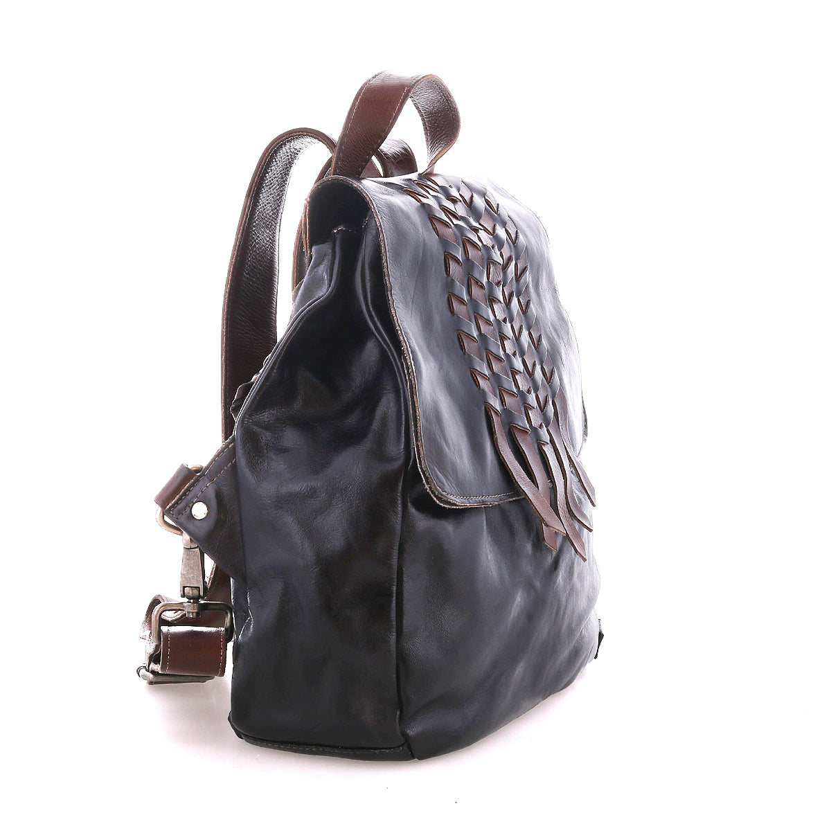 Side view of the Bed Stu Teji dark brown handwoven backpack with woven flap detailing, brown straps, and a silver buckle, set against a white background.