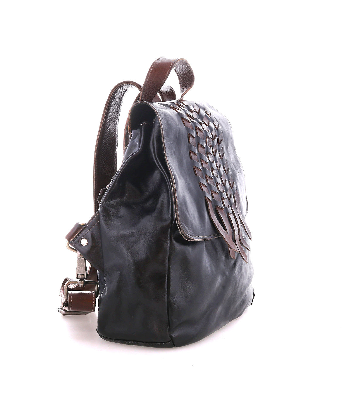 Side view of the Bed Stu Teji dark brown handwoven backpack with woven flap detailing, brown straps, and a silver buckle, set against a white background.