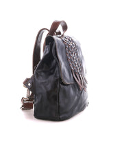 Side view of the Bed Stu Teji dark brown handwoven backpack with woven flap detailing, brown straps, and a silver buckle, set against a white background.
