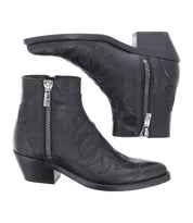 The Bed Stu Tentativa boots are black leather ankle boots with side zippers, low heels, and decorative stitching, inspired by vintage Western style.
