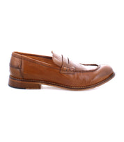 A single brown leather Time loafer by Bed Stu, handcrafted in Italy, featuring a stitch design, flat heel, and penny slot detail on the upper, shown in a side view.