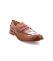 Brown leather penny loafer with a low wooden heel and decorative stitching, handcrafted in Italy on a white background: Time by Bed Stu.